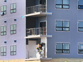 Construction workers are shown at a condominium project on McHugh Street in Windsor on Thursday, March 10, 2022.