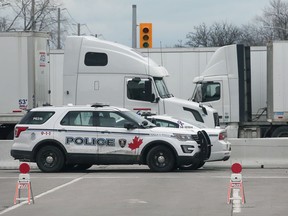 Windsor police vehicles monitor the intersection of Huron Church Road and College Avenue on March 8, 2022.
