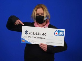 Iris Hittler of Windsor points to her prize cheque from playing Lotto 6/49 in September 2021.