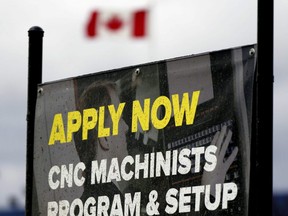 A job hiring sign is seen in Edmonton on May 8, 2020.
