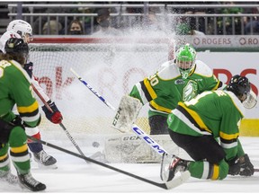 Windsor Spitfires' captain Will Cuylie sneaks in and almost gets a deflection behind London Knights' goalie Brett Brochu during Friday's game.