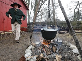 Kelly Woltz keeps an eye on a boiling bot of sap at the maple syrup celebration at the John R. Park Homestead on Saturday, March 19, 2022.