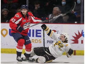 Windsor Spitfires' defenceman Louka Henault, left, sends Sarnia Sting forward Nolan DeGurse crashing to the ice after a collision during Thursday's game at the WFCU Centre.