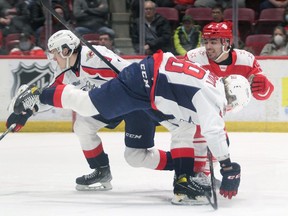 Sault Ste. Marie defenceman Robert Carlisti is turned around while attempting to skate between Windsor Spitfires' defencemen Nathan Ribau, left,) and Andrew Perrott during Sunday's game.