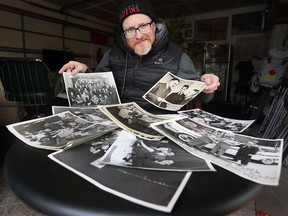 Michael Evans, a local filmmaker displays decades old photos on Tuesday March 8, 2022, he was given recently from a woman who found them in a dumpster.