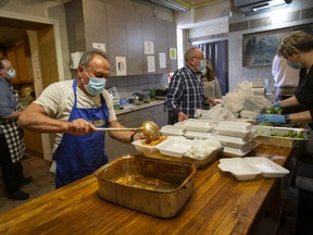 Victor Krolik and other volunteers work at a frenzied pace during a pasta lunch fundraiser for the people of Ukraine at the Windsor Polish Club on Saturday, March 5, 2022.