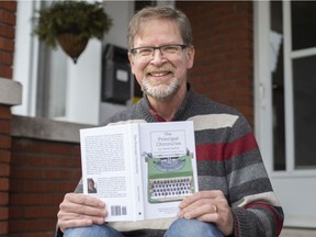 Dave Garlick, a retired principal, is pictured with his book, The Principal Chronicles, a collection of short stories about his time as a high school principal, outside his home on Wednesday, March 2, 2022.