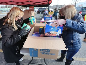 WINDSOR, ONTARIO. MARCH 8, 2022 -    Maureen Curtis, left, and Sue Kearns package donations during the United Way Windsor-Essex County and the Windsor and District Labour Council sixth annual Tampon Tuesday event on Tuesday, March 8, 2022.