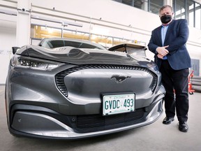 Peter Frise, Director of the Centre for Automotive Research and Education at the University of Windsor is shown with a Ford Mach-E electric vehicle at the faculty of engineering building on Friday, March 25, 2022.