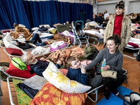 People who fled from Ukraine because of Russian invasion rest at the sports hall of an elementary school in the town of Lubycza Krolewska, in Lublin province, Poland March 1, 2022.