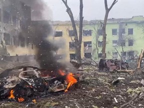 A view shows cars and a building of a hospital destroyed by an aviation strike amid Russia's invasion of Ukraine, in Mariupol, Ukraine, in this handout picture released March 9, 2022.
