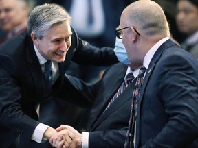 Federal minister of industry François-Philippe Champagne, left, shakes hands with Windsor Mayor Drew Dilkens at a press conference to announce a $5-billion investment to build an EV battery plant in the city.