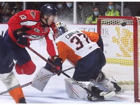 Windsor Spitfires' captain Will Cuylle tucks the puck under the crossbar for a goal on Flint Firebirds' goalie Luke Cavallin earlier this season. The two teams meet in the Western Conference final starting Saturday at the WFCU Centre.