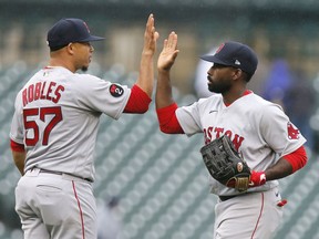 Pitcher Hansel Robles #57 of the Boston Red Sox celebrates with Jackie Bradley Jr. #19 after a 9-7 win over the Detroit Tigers at Comerica Park on April 13, 2022, in Detroit, Michigan.