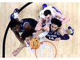 Jalen Wilson, Mitch Lightfoot of the Kansas Jayhawks, Brandon Slater of the Villanova Wildcats and Caleb Daniels of the Villanova Wildcats reach for the ball during the game in the 2022 NCAA Men's Basketball Tournament Final Four semifinal at Caesars Superdome on April 02, 2022 in New Orleans, Louisiana.