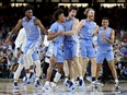 North Carolina Tar Heels players react after defeating the Duke Blue Devils 81-77 in the second half of the game during the 2022 NCAA Men's Basketball Tournament Final Four semifinal at Caesars Superdome on April 02, 2022 in New Orleans, Louisiana.