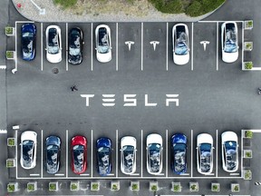 In an aerial view, Tesla cars sit parked in a lot at the Tesla factory on April 20, 2022 in Fremont, California. Tesla reported first quarter earnings that far exceeded analyst expectations with revenue of $18.76 billion compared to expectations of $17.80 billion.