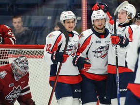 Windsor Spitfires' forwards Ryan Abraham, left, Daniel D'Amico and Matthew Maggio celebrate D'Amico's first goal in Friday's 7-1 win over the Guelph Storm at the Sleeman Centre in front of Guelph goalie Owen Bennett.