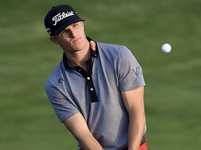 Morgan Hoffmann chips onto the 18th green during the first round of the Houston Open golf tournament, Thursday, March 31, 2016, in Humble, Texas