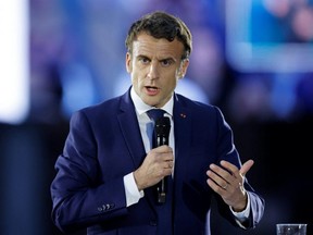 French President Emmanuel Macron, candidate for re-election in the 2022 French presidential election, delivers a speech during a campaign meeting at the Place du Chateau near the Cathedral in Strasbourg, France, Tuesday, April 12, 2022.