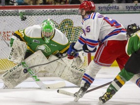 Brett Brochu of the London Knights keeps his eyes locked on the puck as Reid Valade of the Kitchener Rangers breaks in on him with Gerard Keane in hot pursuit while the Rangers are shorthanded in the second period at Budweiser Gardens in London on Monday, Feb. 21, 2022.  (Mike Hensen/The London Free Press)