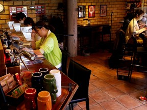 Customers work on their manuscripts at the Manuscript Writing Cafe, which is designed for writers who are working on a deadline, in Tokyo, Japan, April 21, 2022.