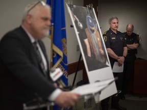 Acting chief of police, Jason Bellaire, looks on as superintendent of investigations, Jason Crowley, provides an update on the shooting outside of a bowling alley in Forest Glade over the weekend, while at police headquarters on Tuesday, April 12, 2022.
