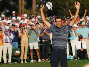 Scottie Scheffler celebrates on the 18th green after winning the Masters at Augusta National Golf Club on April 10, 2022 in Augusta, Ga.