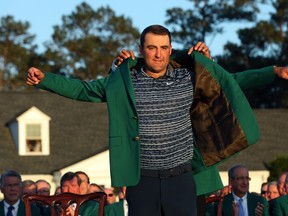 Scottie Scheffler has the Green Jacket slipped on by last year's Masters champion Hideki Matsuyama after Scheffler won at Augusta National yesterday.