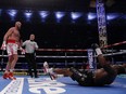 Tyson Fury knocks down Dillian Whyte to retain the WBC heavyweight world championship at Wembley Stadium in London, Saturday, April 23, 2022.