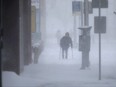 A person makes their way through heavy snow as a snowstorm arrives in Winnipeg, April 13, 2022.