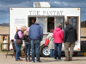 The Amherstburg Farmers Market kicked off the season on Saturday, April 9, 2022 at the GL Heritage Brewery.  People line up to purchase food at The Pantry mobile food booth.