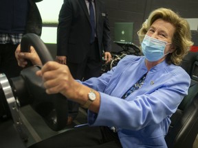 Helena Jaczek, Minister of the Federal Economic Development Agency for Southern Ontario, gets behind the wheel in the VR cave at the Invest WindsorEssex Automobile and Innovation Center, Thursday, April 21, 2022.