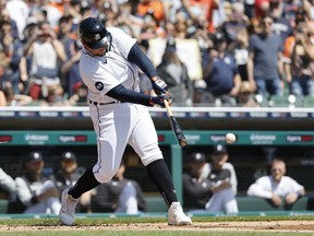 Detroit Tigers designated hitter Miguel Cabrera hits a single for his 3000th career hit in the first inning against the Colorado Rockies at Comerica Park.