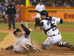 New York Yankees first baseman Anthony Rizzo slides safe into home plate during the eighth inning against Detroit Tigers catcher Tucker Barnhart at Comerica Park.