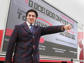 Franco Terrazzano, federal director with the Canadian Taxpayers Federation poses in front of the organization's Debt Clock on Wednesday, April 20, 2022 during a stop in Windsor.