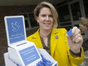 Nancy Brockenshire, executive director of Hospice of Windsor and Essex County, displays the Hospice Dove Pin, a campaign to raise money for hospice care, on Wednesday, April 27, 2022.