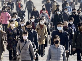 People wearing protective face masks commute amid concerns over the new coronavirus disease (COVID-19) in Pyongyang, North Korea March 30, 2020, in this photo released by Kyodo.