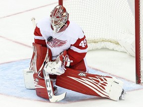 Detroit Red Wings goaltender Magnus Hellberg makes a save against the New Jersey Devils during the third period at Prudential Center.