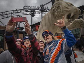 Baseball fans take a group photo outside of Comerica Park in Detroit, MI, where the Detroit Tigers are hosting the Chicago White Sox to kick off the 2022 season of Major League Baseball, on Friday, April 8, 2022.