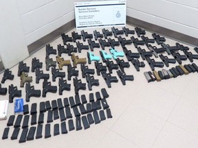 This handout photo from the Canada Border Services Agency shows 56 prohibited firearms seized Nov. 1, 2021, at the Blue Water Bridge in Point Edward.