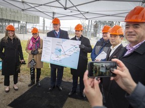 From left, Jay Armitage, VP marketing and communications for Hydro One, Hilda MacDonald, mayor of Leamington, Drew Dilkens, mayor of Windsor, Stephen Crawford, parliamentary assistant to energy minister Todd Smith, Stephen McKenzie, president and CEO, Invest Windsor Essex, Michael Kim, construction lead for LG Energy Solutions, and Zach Leroux, North American battery industrialization for Stellantis, pose for a photo at the Lauzon Transfer Station after announcing new transmission line projects for Southwestern Ontario, on Monday, April 4, 2022.