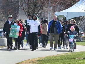Participants stroll along during the Windsor River Walk event on Saturday, April 16, 2022.