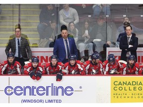 Windsor Spitfires assistant coach Andy Delmore, left, head coach Marc Savard, centre, and associate coach Jerrod Smith have been an impressive trio behind the bench.
