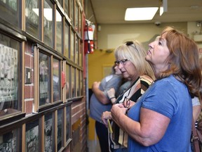 Former students look at the banners and team photos at General Amherst High School. The school held an open house and reunion on Saturday, May 14, 2022 as the school marks both its closing and 100th anniversary.