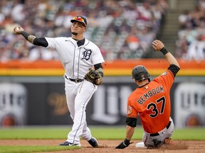 Javier Baez of the Detroit Tigers throws to first base as Anthony Bemboom of the Baltimore Orioles is out at second during the top of the third inning at Comerica Park on May 14, 2022 in Detroit, Michigan.