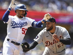 Eduardo Rodriguez of the Detroit Tigers tags out Mookie Betts of the Los Angeles Dodgers at first base to end the fourth inning at Dodger Stadium on May 01, 2022 in Los Angeles, California.