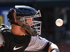Jacob Stallings of the Miami Marlins takes a ball off his mask against the Arizona Diamondbacks during the ninth inning at Chase Field on May 11, 2022 in Phoenix, Arizona. Marlins won 11-3.