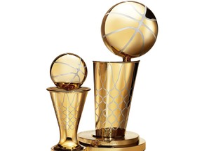 The redesigned Bill Russell MVP Trophy, left, and the Larry O’Brien Championship Trophy. The Russell trophy is now finished completely in vermeil gold to match the O’Brien trophy.