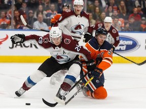 Edmonton Oilers' Connor McDavid (97) battles Colorado Avalanche's Nathan MacKinnon (29) during the first period of a NHL hockey game at Rogers Place in Edmonton, on Thursday, Nov. 14, 2019.